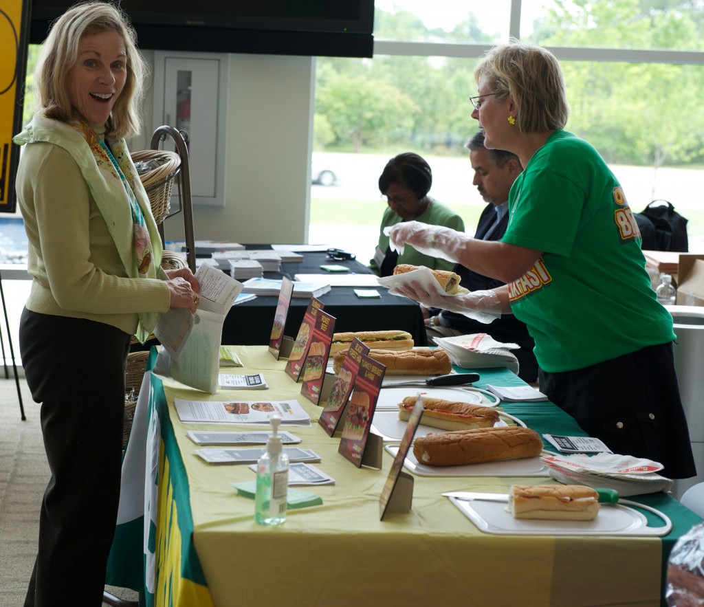 People connecting with wellness providers at an IAB employee health fair