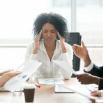 Stressed african businesswoman tired or suffering from headache